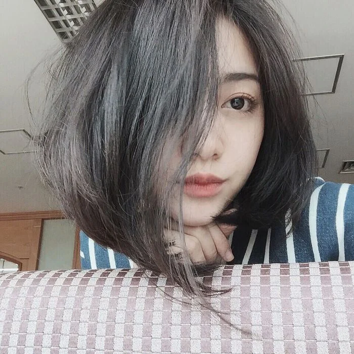 Cô gái có mái tóc ngắn che một phần khuôn mặt